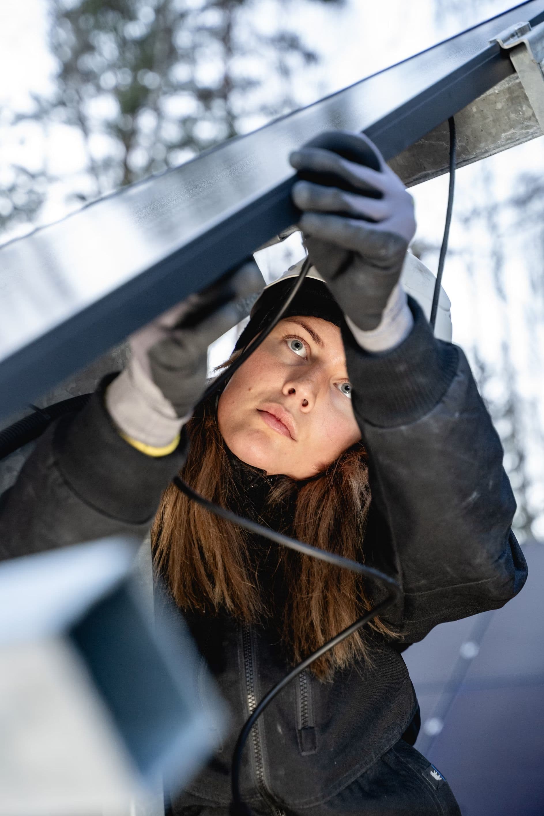 A woman fixing a solar panel